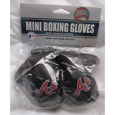 Miniature boxing gloves hanging on the rear view mirror of an old